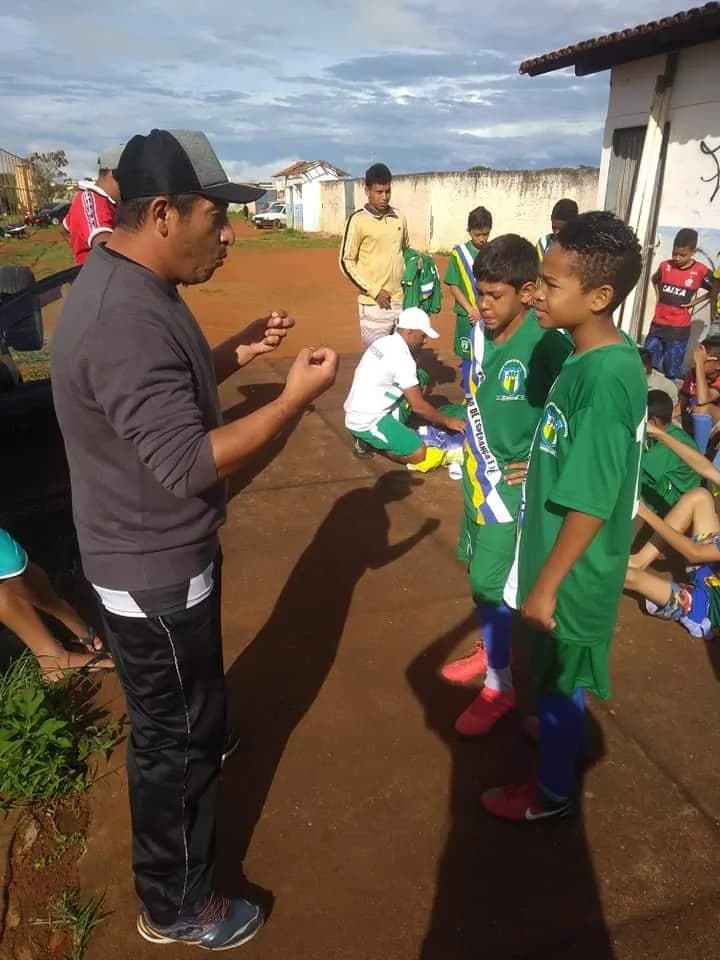 Treinador passando instruções para o grupo antes do treino